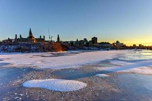 parlament kulle och de kanadensisk hus av parlament i Ottawa, kanada tvärs över de frysta ottawa flod under vintertid. foto