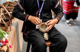 närbild och beskära händer av thailändare demonstration av ristade silver- vatten skål på chiang maj, thailand. foto