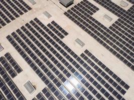 antenn se av sol- paneler monterad på tak av stor industriell byggnad eller lager. foto