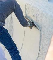 arbetstagare glättning våt slå samman plåster med murslev foto