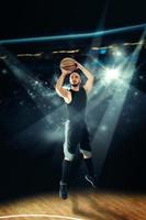 sportsman spelar basketboll och shootnig tre punkt skott foto