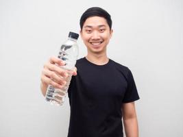 asiatisk man visa vatten flaska Lycklig leende vit bakgrund foto