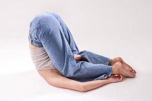 porträtt av skön ung kvinna med atletisk flexibel kropp håller på med ben stretching. isolerat foto