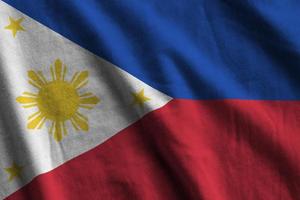 filippinerna flagga med stor veck vinka stänga upp under de studio ljus inomhus. de officiell symboler och färger i baner foto
