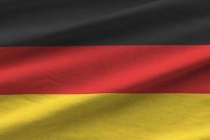 Tyskland flagga med stor veck vinka stänga upp under de studio ljus inomhus. de officiell symboler och färger i baner foto
