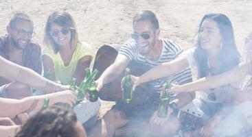sommar, högtider, semester, musik, Lycklig människor begrepp - grupp av vänner med gitarr har roligt på de strand foto
