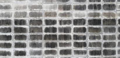 smutsig eller röra vit betong vägg för bakgrund. sömlös mönster konst av svart, grå eller grå cement tegel tapet. fyrkant blockera, linje och geometrisk form begrepp foto