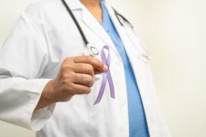 asiatisk kvinna läkare med lila band, tecken av alzheimers sjukdom dag, pankreas- cancer, epilepsi, lupus. foto