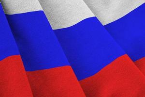ryssland flagga med stor veck vinka stänga upp under de studio ljus inomhus. de officiell symboler och färger i baner foto