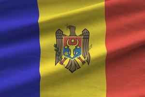 moldavien flagga med stor veck vinka stänga upp under de studio ljus inomhus. de officiell symboler och färger i baner foto