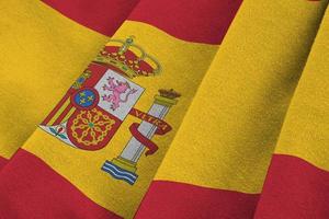 Spanien flagga med stor veck vinka stänga upp under de studio ljus inomhus. de officiell symboler och färger i baner foto