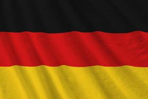 Tyskland flagga med stor veck vinka stänga upp under de studio ljus inomhus. de officiell symboler och färger i baner foto