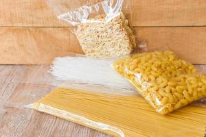 rå spaghetti italiensk pasta okokt - rå makaroner , omedelbar spaghetti och ris vermiceller i paket pasta produkt torr mat , icke förgänglig mat foto
