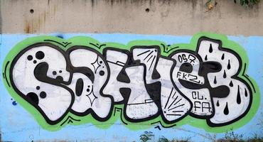 bakgrund bild av en betong vägg med en bit av abstrakt graffiti mönster. gata konst, vandalism och ungdom hobbies foto