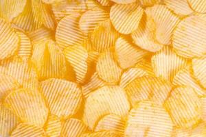 gul Krispig åsförsedda potatis pommes frites stänga upp. mat bakgrund foto