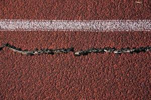 skadad knäckt löpning atletisk Spår detalj foto