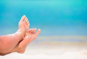 närbild av sandiga fötter på en strand foto
