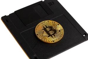 skär de gyllene bitcoin av de kör för diskett foto