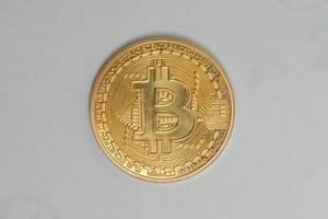 guld mynt av bitcoin på en grå bakgrund foto