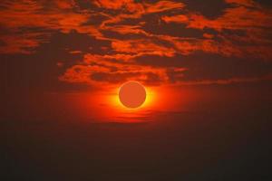 sol- förmörkelse på klar röd orange himmel solnedgång i de kväll foto