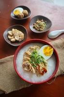 congee gröt med kyckling skiva, tofu, ägg. congee gröt från hong kong. kinesisk mat foto