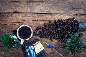 kaffe, blommor och kreditkort på träbakgrund foto