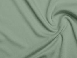 grön Färg sammet tyg textur Begagnade som bakgrund. ljusoliven grön tyg bakgrund av mjuk och slät textil- material. där är Plats för text. foto