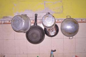 matlagning redskap hängande på de kök vägg foto