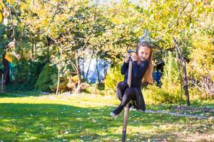 förtjusande liten flicka i halloween som kostym har roligt utomhus foto