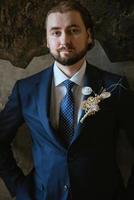 porträtt av en manlig brudgum i en blå kostym i de morgon- frisör foto