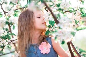 söt flicka i blomning äpple träd trädgård njut av de värma dag foto