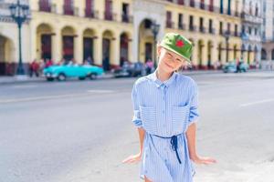 turist i populär område nära el capitolio i havana stad, kuba. porträtt av unge bakgrund årgång klassisk amerikan bil foto