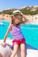söt liten flicka njuter segling på båt under sommar semester foto