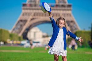 förtjusande Lycklig liten flicka i paris bakgrund de eiffel torn under sommar semester foto