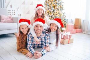 Lycklig ung familj med barn innehav jul presenterar foto