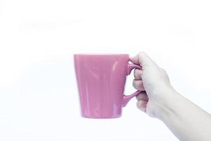 hand som håller en rosa kopp foto