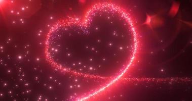 abstrakt lysande festlig hjärta kärlek röd från de rader av magisk energi från partiklar på en mörk bakgrund för hjärtans dag. abstrakt bakgrund foto