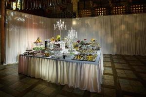 utsökt godis bar på lyx bröllop reception. exklusiv dyr catering. tabell med modern desserter, cupcakes, sötsaker med frukter. bebis eller brud- dusch. Semester firande. selektiv fokus foto