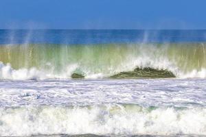 ytterst enorm stor surfare vågor på strand puerto escondido Mexiko. foto