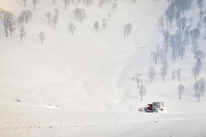 snowcat med stuga till ta skidåkare snowboardåkare snålskjuts utför i avlägsen kaukasus berg. ratrak i foto