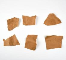 trasig brun bitar av pergament papper på en vit bakgrund foto