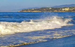 ytterst enorm stor surfare vågor på strand puerto escondido Mexiko. foto