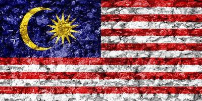 malaysiska flagga på en texturerad bakgrund. begrepp collage. foto