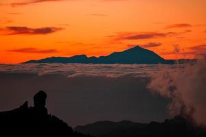 spektakulär solnedgång ovan de moln av de teide vulkan nationell parkera på teneriffa. foto