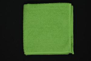 en grön trasa för avtorkning. en frotté handduk. en trasa för rengöring de lokal. en grön handduk. foto