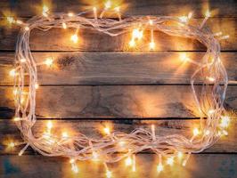 jul dekoration bakgrund - årgång plankerad trä med lampor med kopia Plats text. foto