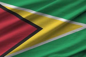 guyana flagga med stor veck vinka stänga upp under de studio ljus inomhus. de officiell symboler och färger i baner foto