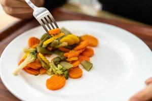 de begrepp av friska äter. äta grönsaker med en gaffel foto