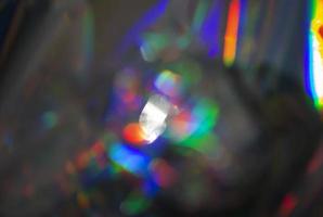 lysande bakgrund av färgrik bokeh med en holografiska effekt. de effekt av optisk linser. foto