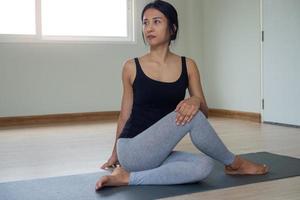 kvinnor är håller på med sittande vrida övningar för hälsa och en fastare kropp. yoga begrepp foto